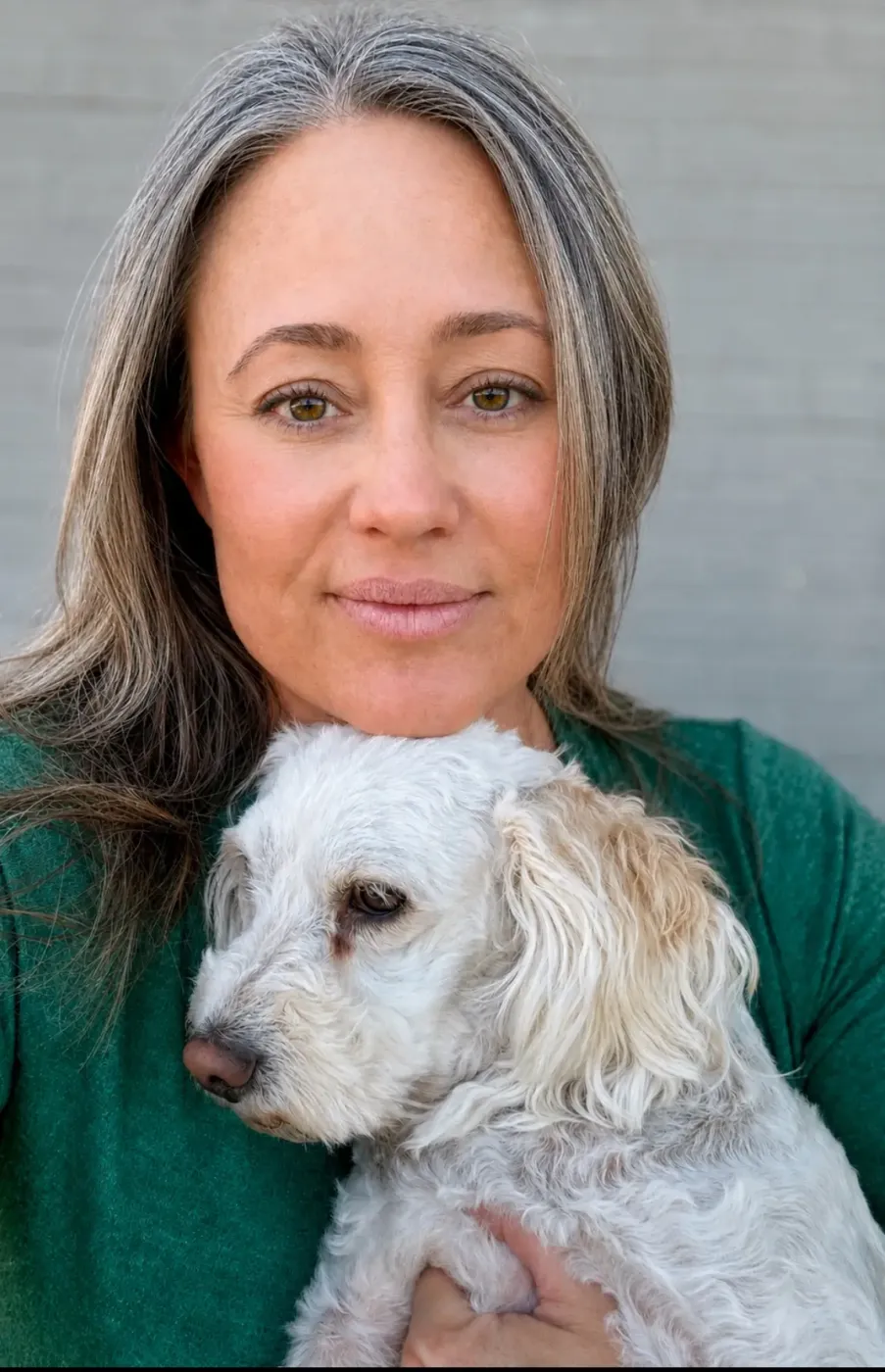 Reina McRae, founder of Arizona Fur Baby Rescue, holding a rescued dog